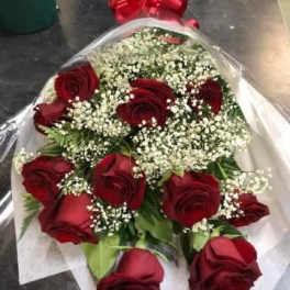 Bouquet of red roses with baby's breath wrapped in white paper