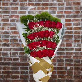 Bouquet of red roses with white filler and gold-and-white wrapping