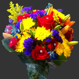 Colorful bouquet of roses, lilies, and daisies in clear wrap