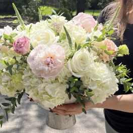 Large bouquet of white and blush flowers in a vase