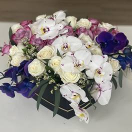 Box arrangement of white and pink roses with white and purple orchids