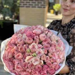 Large bouquet of pink roses wrapped in white paper