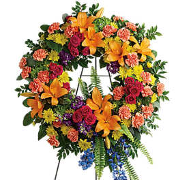 Large multicolored floral wreath on a stand