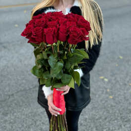 Large bouquet of red roses with a red ribbon wrap