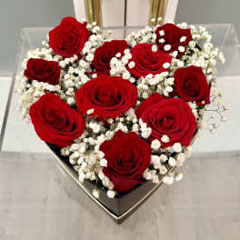 Heart-shaped box of red roses with white baby's breath