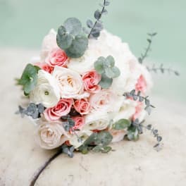 Round bouquet of white and pink roses with eucalyptus