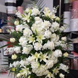 Large white floral spray with roses and lilies