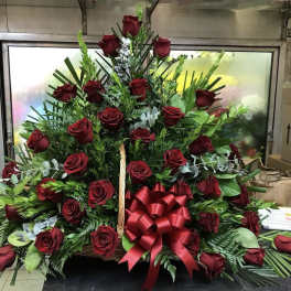 Basket arrangement of red roses with a large red ribbon bow