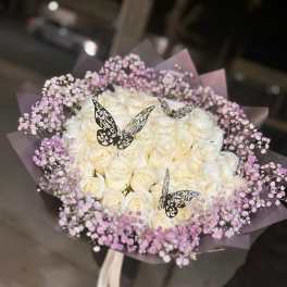 Bouquet of white roses with pink baby's breath and butterfly picks