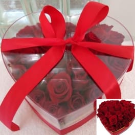 Heart-shaped box of red roses tied with a large red ribbon