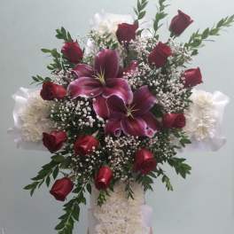 Tall floral standing spray with red roses, purple lilies, and white flowers