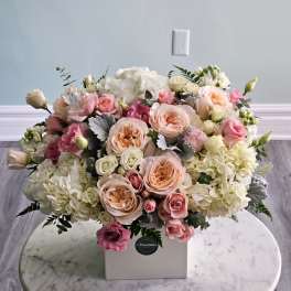 Large pastel bouquet in a white box with roses and hydrangeas