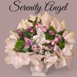Pink and purple bouquet with an angel figurine in a white vase