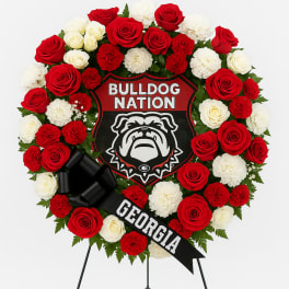 Red and white rose wreath with a bulldog emblem and Georgia ribbon on a stand