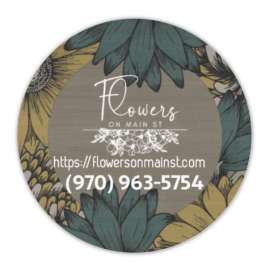 Round floral shop sign with sunflower artwork and store name