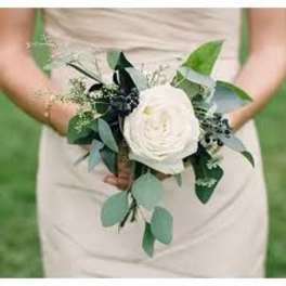 Bride holding a white flower bouquet with eucalyptus
