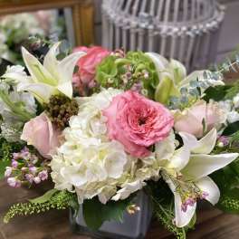 Pink and white floral arrangement in a gray vase