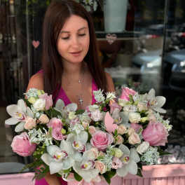 Woman holding a pink box of pink and white flowers