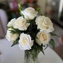 White rose bouquet in a clear glass vase