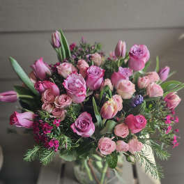 Pink rose and tulip bouquet in a glass vase