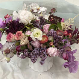 Mixed bouquet in a white vase with purple, pink, and white flowers