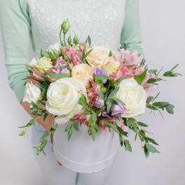 Handheld bouquet of white and pastel roses with pink alstroemeria