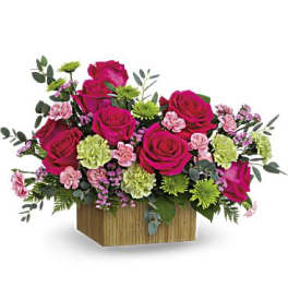 Pink rose arrangement in a wooden box with green and lavender accents