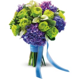 Hand-tied bouquet of bright green blooms, purple hydrangeas, and white calla lilies with blue ribbon
