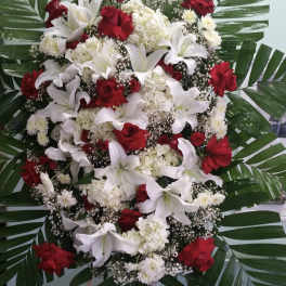 Large standing floral spray with red roses and white lilies