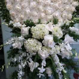 Large white rose and hydrangea standing spray with green foliage