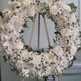 White floral wreath on a wooden easel