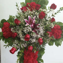 Large red floral cross with roses and lilies