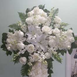 White floral cross arrangement with roses and lilies
