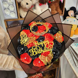 Red and black rose bouquet with gold birthday topper and butterflies