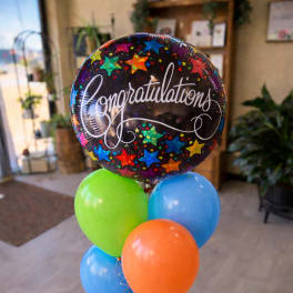 Cluster of colorful balloons with a large "Congratulations" balloon