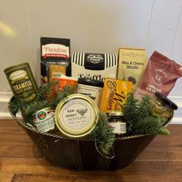 Gift basket with assorted cookies, honey, and jam in a decorative tray