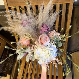 Pastel bouquet with roses, hydrangea, and airy dried grasses