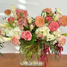 Pink and white mixed bouquet in a clear glass vase