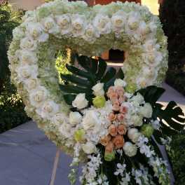 Heart-shaped floral wreath with white roses and hydrangeas