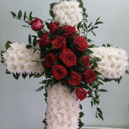 Cross-shaped floral tribute with red roses and white chrysanthemums