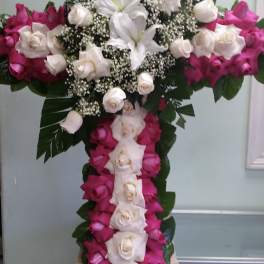 Cross-shaped floral arrangement with pink and white roses and white lilies