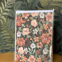 Floral greeting card with orange and white flowers in a clear sleeve