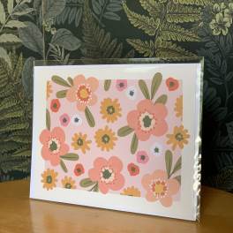 Floral greeting card with pink and orange flowers in a clear sleeve