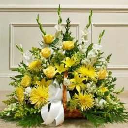 Yellow and white flower basket with roses, lilies, mums, and snapdragons accented by a large white bow