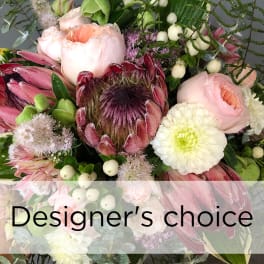 Mixed bouquet with pink and white blooms and a large protea