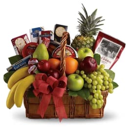 Fruit basket with chocolates and a red ribbon