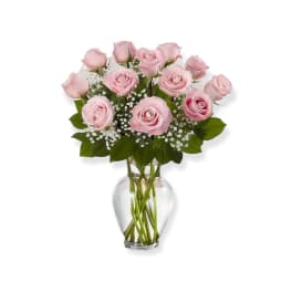 Pink roses arranged in a clear glass vase