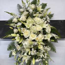 Large white floral standing spray with roses and lilies