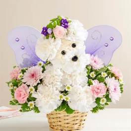 White and pink flower arrangement in a wicker basket with purple butterfly wings