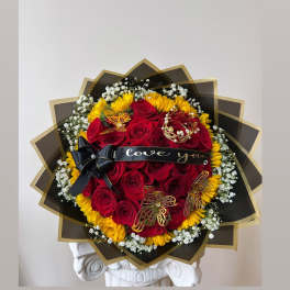 Bouquet of red roses and yellow sunflowers with a black ribbon